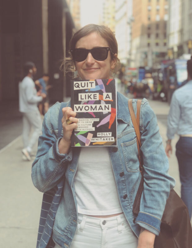 Holly Whitaker holding a copy of Quit Like A Woman