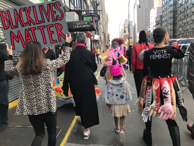 Avery marching with Diana Kane (in leopard print)