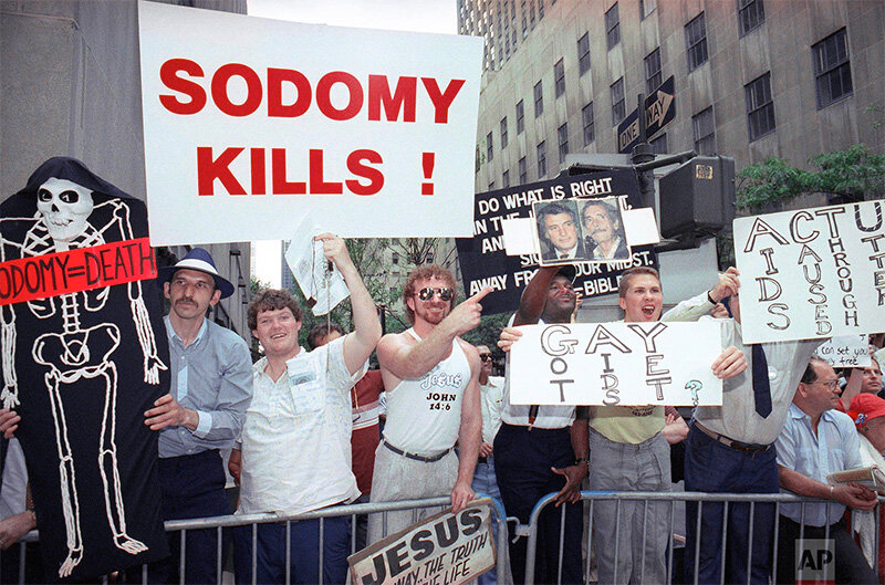 During the ‘80s the AIDS epidemic created a crisis that forced many gay men in the US and elsewhere to go public. This caused a severe backlash but also forced people to acknowledge the LGBTQ+ in their midst –ultimately leading the way to more acceptance as the community refused to hide any longer.