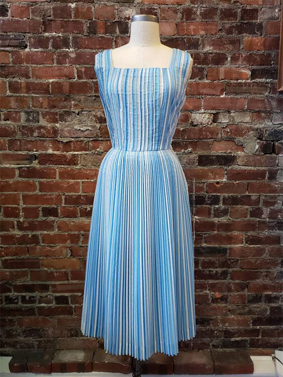 A striped pleated sundress from the ‘50s in many shades of blue