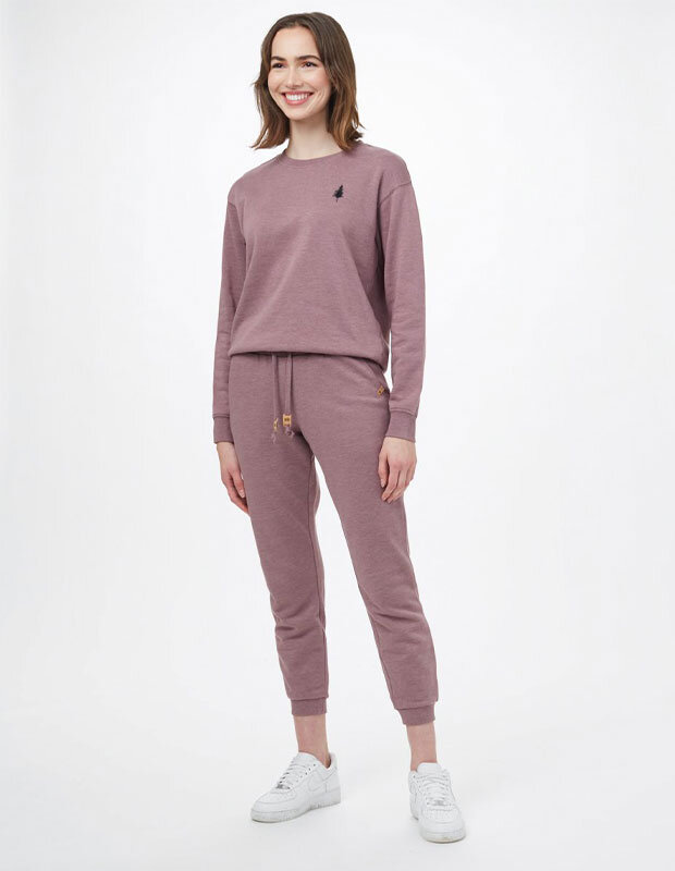 Woman in mauve recycled poly sweat suit by Tentree