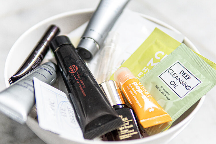 A bowl of beauty samples from our editor’s bathroom