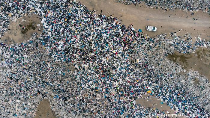 Overhead shot of mountains of discarded clothes in Atacama desert