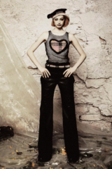 person wearing mesh top with heart and black pants