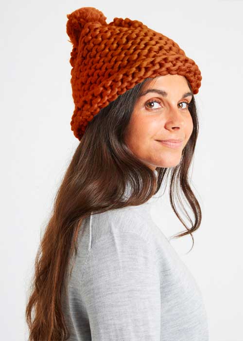Model wears Wool and the Gang DIY knitted beanie