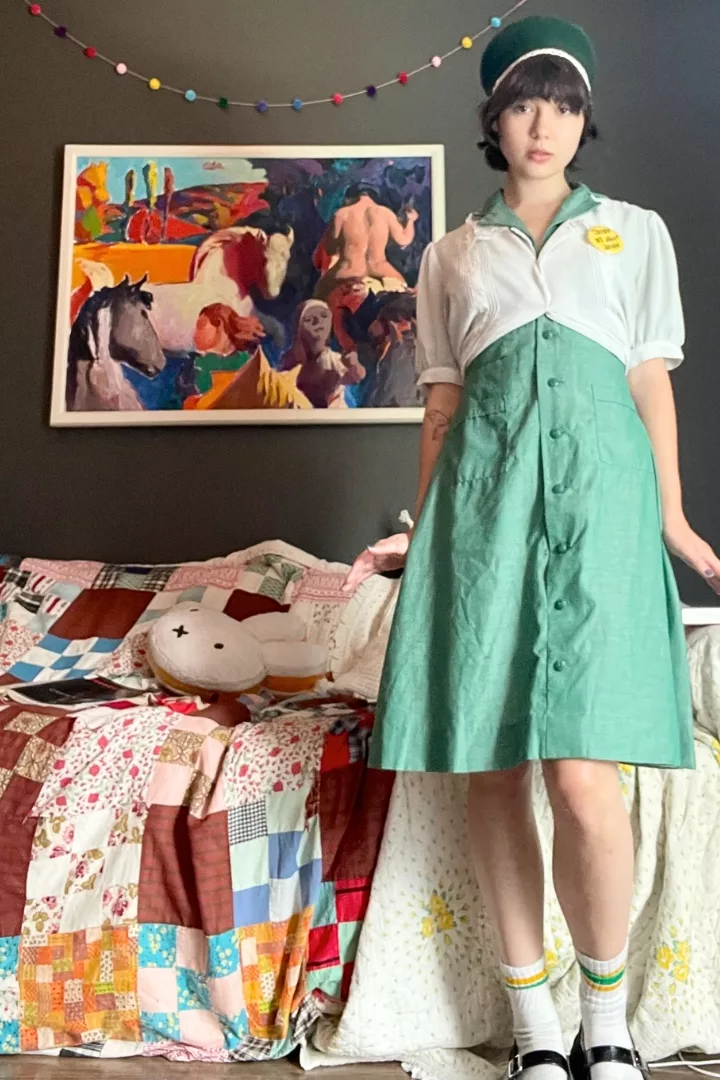Harper Haynes wearing a girl scout uniform with a tiny white top over it