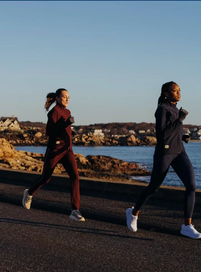 two women running in tracksmith leggings and jackets
