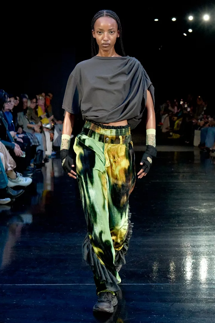 woman wearing a black to and mint green, black and gold velvet pants on collina strada fw24 runway